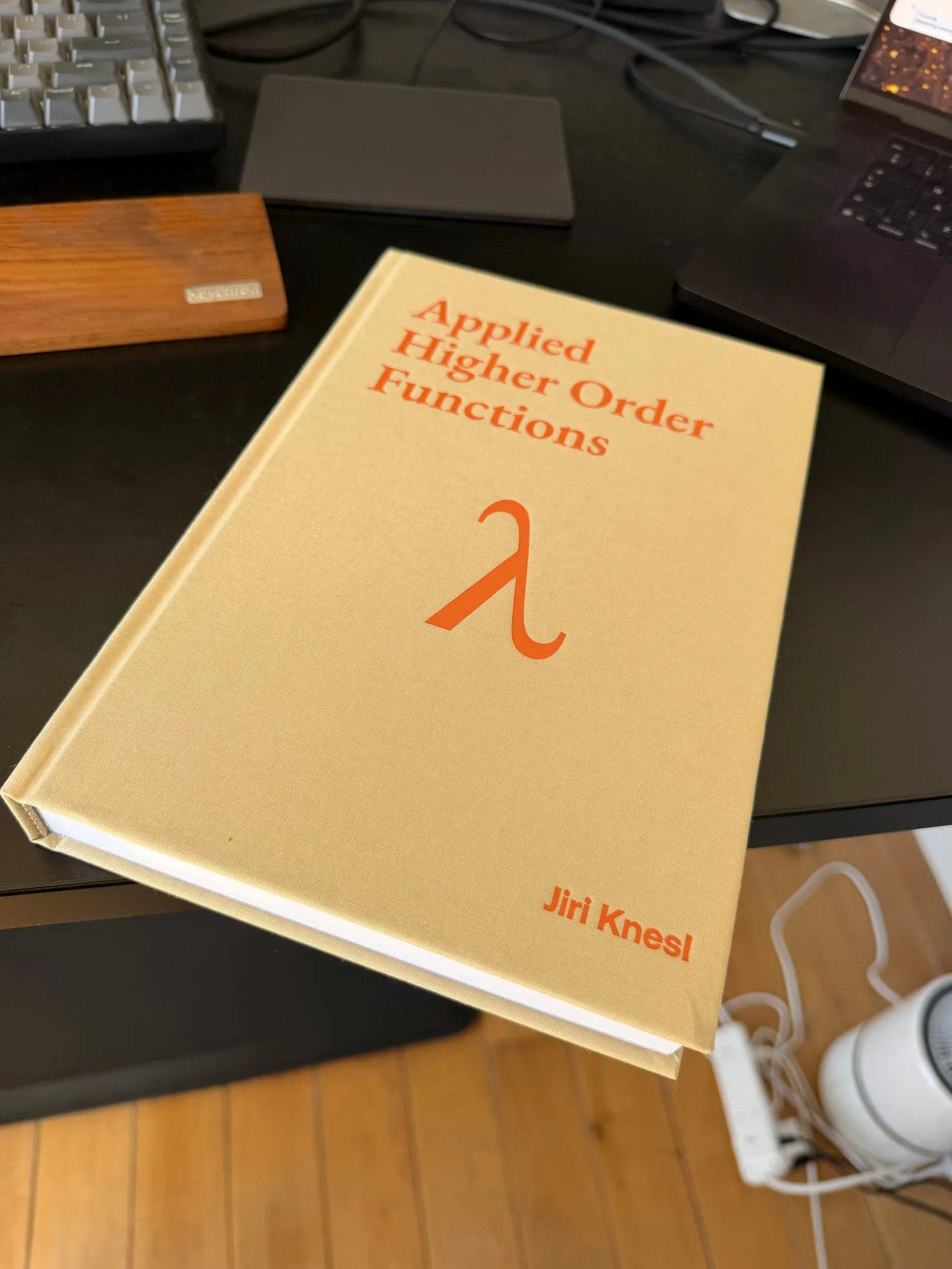 The hardback of Applied Higher Order Functions on a desk