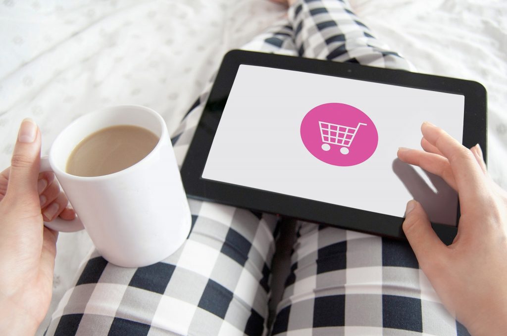 Woman with tablet and there is a ecommerce logo