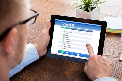 Man with tablet and checklist on screen